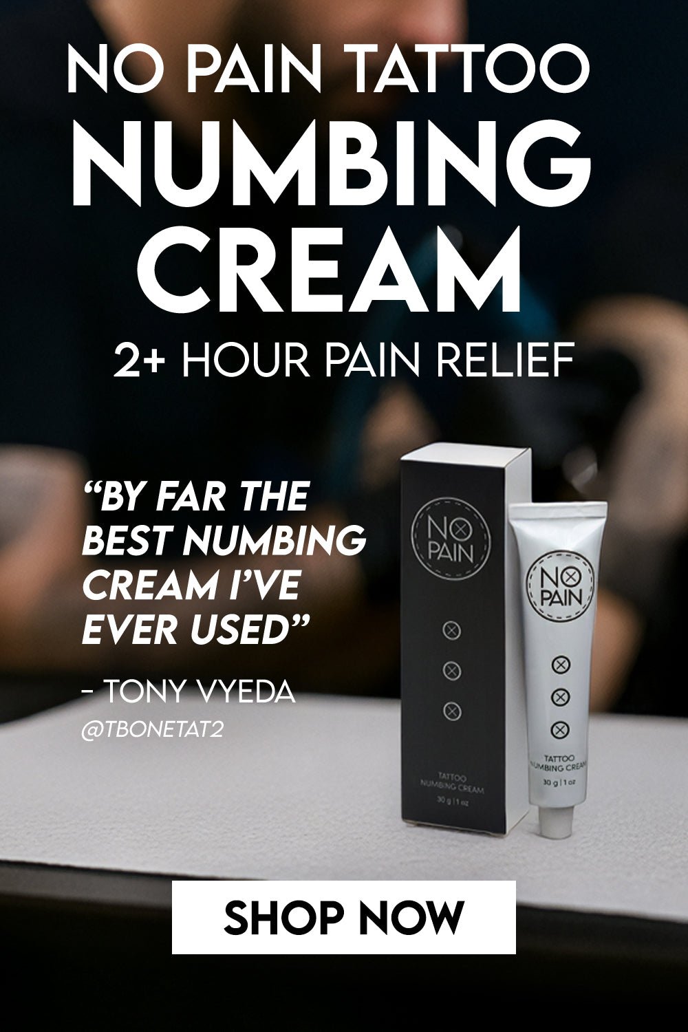 No Pain Tattoo Numbing Cream box and tube on a tattoo shop desk — featuring Tony Vyeda quote: by far the best numbing cream I've ever used