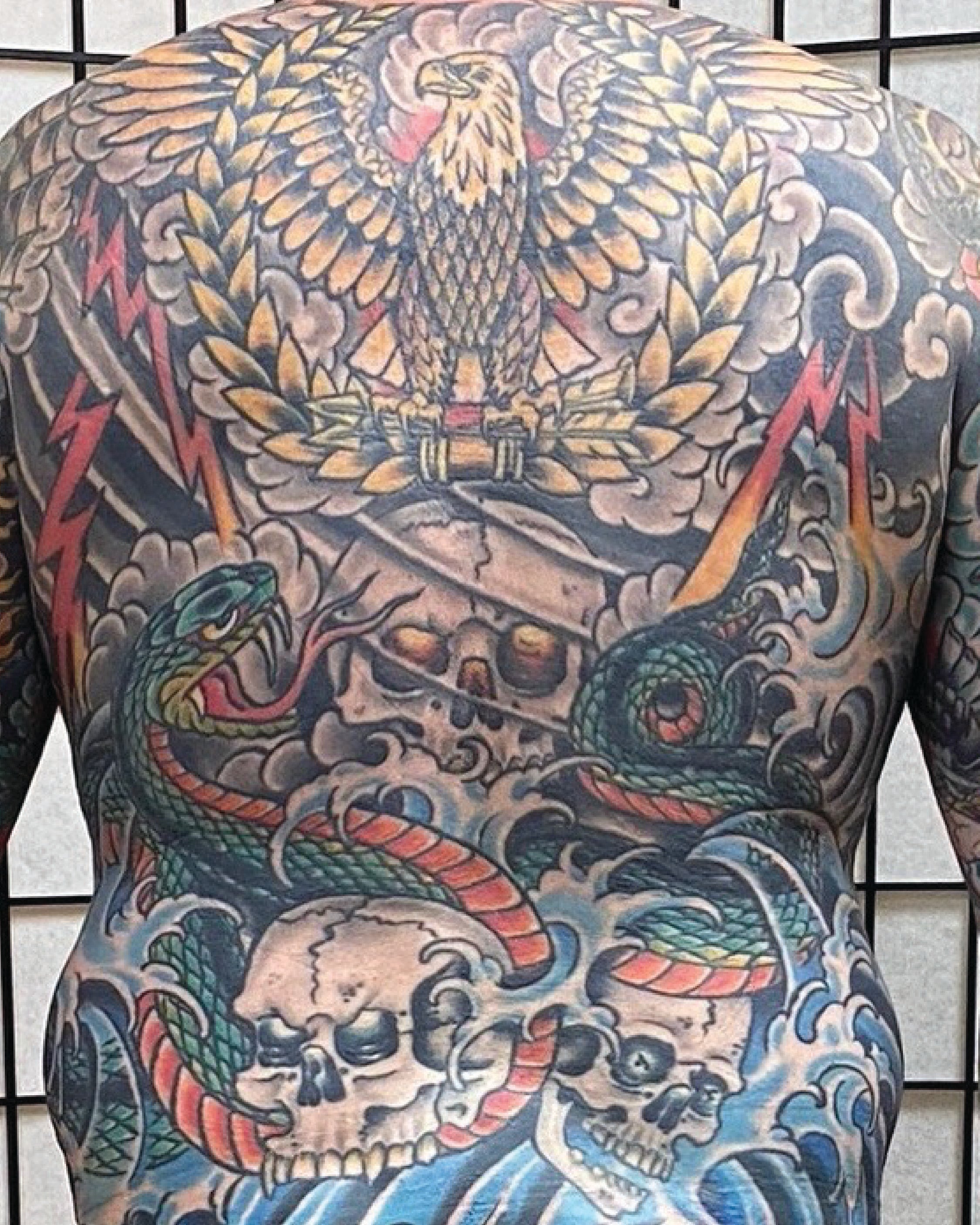 Full-back-piece-tattoo-traditional-style-bold-lines.
