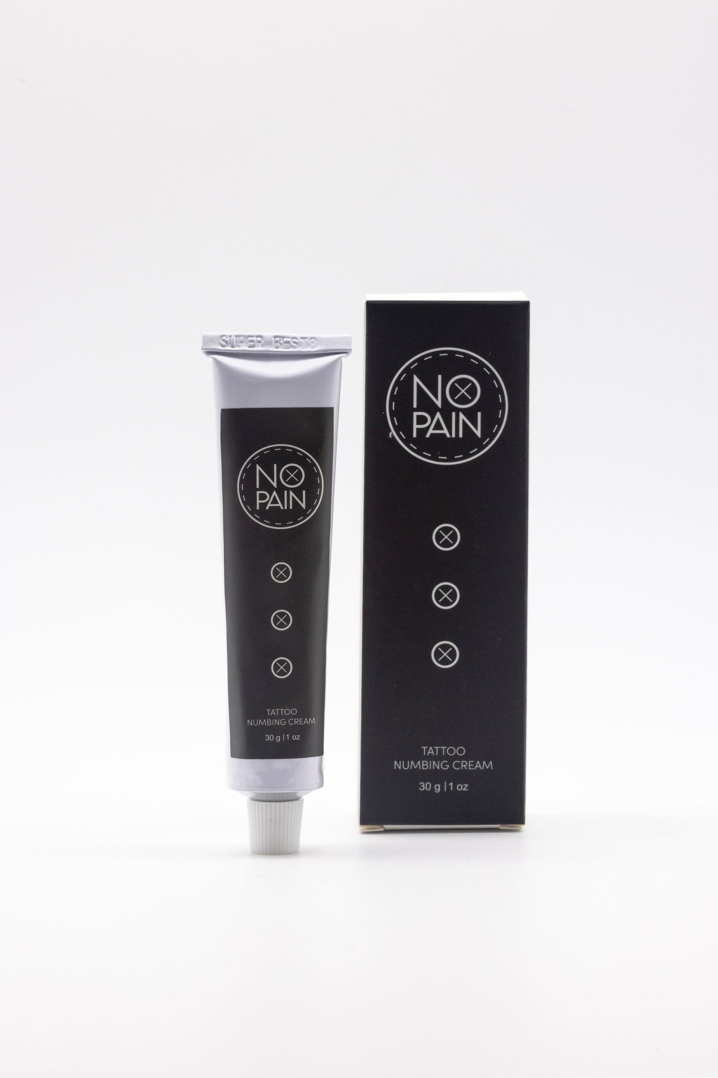 A tube of No Pain Tattoo Numbing Cream labeled "My Store" stands next to its black box packaging. Both the tube and the box display the same circular logo and text, with the information "Tattoo Numbing Cream, 30g | 1 fl oz" beneath the logo, ensuring pain-free tattooing for those seeking tattoo comfort.